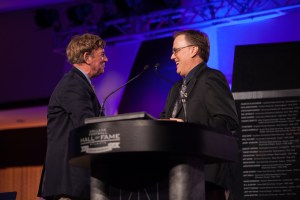 FWAA President Chris Dufresne of the Los Angeles Times presents the Bert McGrane Award to longtime New York Daily News writer Dick Weiss on Aug. 28, 2013 at The Omni Hotel in Atlanta during the Hall of Fame Enshrinement Ceremony.  (Photo Courtesy of College Football Hall of Fame Atlanta.)