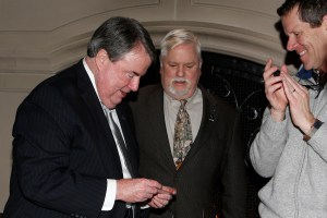 At FWAA Past Presidents Dinner on Friday night at the Dallas Country Club, the National Football Foundation's Steve Hatchell (left) was surprised with the word he was the 2015 FWAA Bert McGrane winner. FWAA Executive Director Steve Richardsonl (center) and Ivan Maisel, an FWAA Past President, look on.  (Melissa Macatee photo)