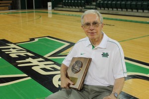 Jack Bogaczyk on the Cam Henderson Center floor with one of his three NSSA West Virginia Sports Writer of the Year awards.